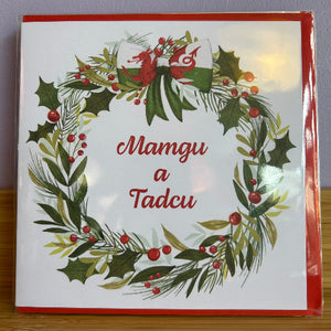 Christmas card with wreath design and text on a white background