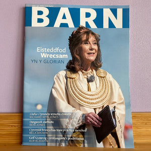 Magazine cover with a woman in traditional attire against a blue sky, titled 'BARN'.