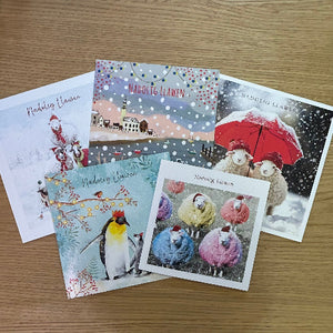 Collection of Christmas-themed greeting cards on a wooden surface