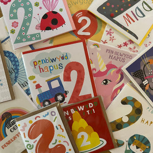 Collection of colorful greeting cards with various designs and text.
