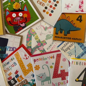 Collection of colorful greeting cards with various designs and text.