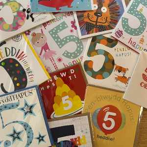 Collection of colorful greeting cards with various designs and text.