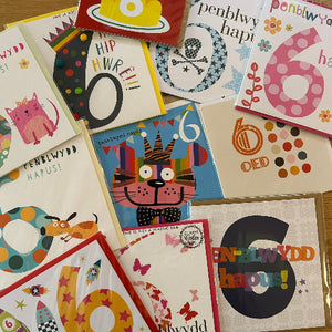 Collection of colorful greeting cards with various designs and text.