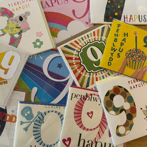 Collection of colorful greeting cards with various designs and text.