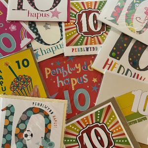 Collection of colorful greeting cards with '10 hapes' text, featuring various designs and colors.