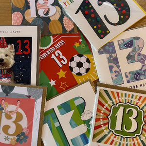 Collection of greeting cards with number 13 on various designs