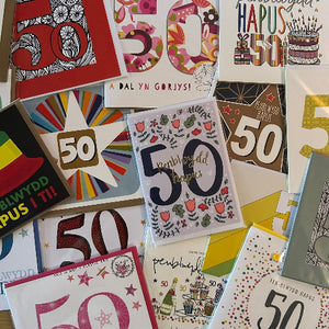 Collection of 50th birthday cards with various designs and colors.