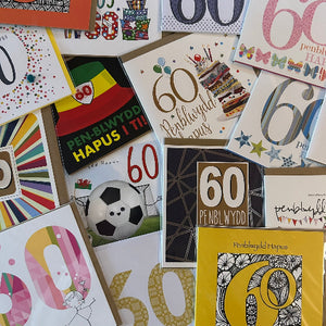 Collection of 60th birthday cards with various designs and colors.