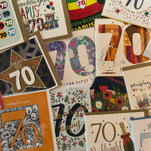 Collection of 70th birthday cards with various designs and colors.