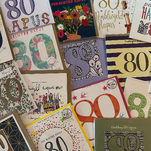 Collection of greeting cards with various designs and numbers, including the number 80.