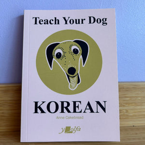 Book titled 'Teach Your Dog Korean' with a dog illustration on a blue background
