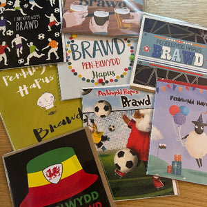 Collection of greeting cards with various designs on a wooden surface