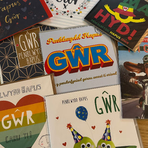 Collection of greeting cards with various designs and text, including 'GWR' and colorful graphics.