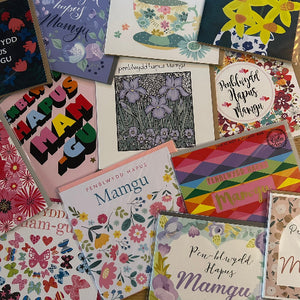 Collection of colorful greeting cards with various designs and text.
