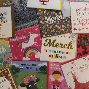 Collection of colorful greeting cards with various designs and text.