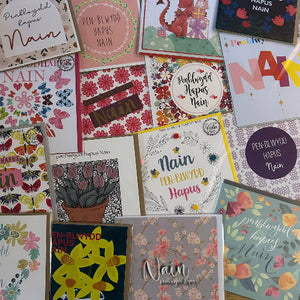Collection of greeting cards with various designs and text on a white background