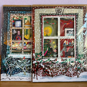 Decorative window scene with Christmas-themed elements on a snowy background