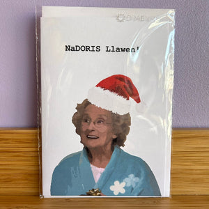 Card with a person wearing a Santa hat and text 'NaDORIS Llawer' on a white background.