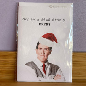 Card with a person wearing a Santa hat and text on a white background