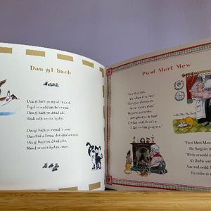 Open book with illustrations and text on a wooden surface