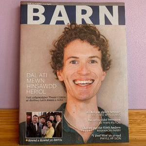 Magazine cover with a smiling man's face and text on a purple background