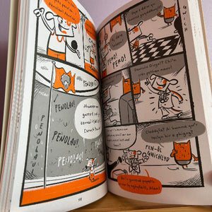 Open book with cartoon illustrations on a wooden surface