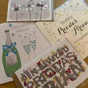 Collection of greeting cards with various designs on a wooden surface
