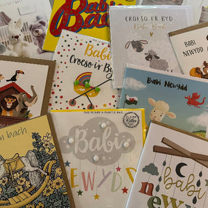 Collection of baby-themed greeting cards with various designs and text.