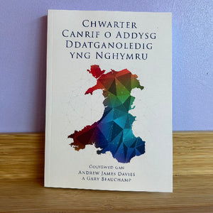 Book with a colorful map of Wales on a wooden surface 