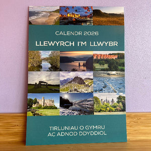 Calendar 2026 cover with Welsh text and scenic images on a purple wall.