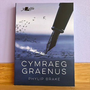 Book cover of 'Cymraeg Graenus' by Phylip Brake with an inkwell and birds on a beach.