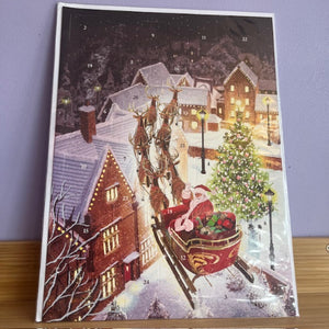 Advent calendar with Santa Claus and reindeer scene on a snowy village background