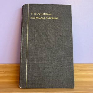 Vintage book with text on a wooden surface and purple background