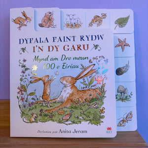 Children's book with rabbit illustration on a wooden surface and purple background