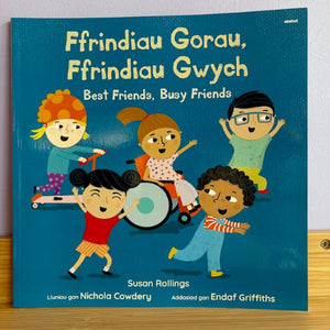 Children's book titled 'Ffrindiau Gorau, Ffrindiau Gwych Best Friends, Busy Friends' with illustrations of children on a blue background.