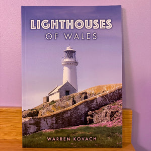 Book titled 'Lighthouses of Wales' by Warren Kovach with a lighthouse on the cover.