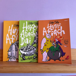 Three books titled 'Hufe Afach', 'Hufe Afach Dai', and 'Hylif Afach' on a wooden shelf with a purple wall background.