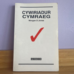 Book titled 'Cywiriadur Cymraeg' by Morgan D Jones with a red checkmark on a white background.