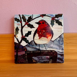 Artistic depiction of a red bird on a branch with berries against a pink wall.