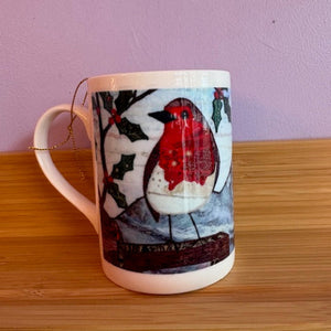 Mug with a red robin design on a wooden surface