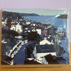 Artistic depiction of a coastal town with houses and a body of water.