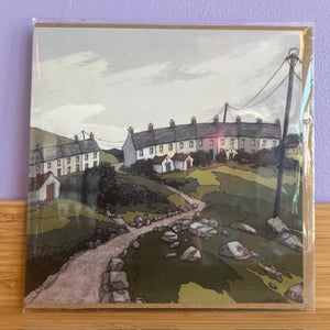 Greeting card with a painted scene of a village on a purple background